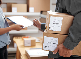 Professional RavenRoute UK courier driver making a delivery